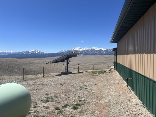 view of yard featuring a rural view and a mountain view