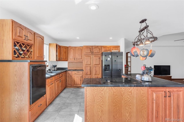 kitchen with black appliances, sink, a kitchen island, pendant lighting, and light tile patterned floors