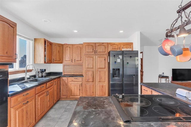 kitchen with stainless steel refrigerator with ice dispenser, sink, hanging light fixtures, and light tile patterned floors