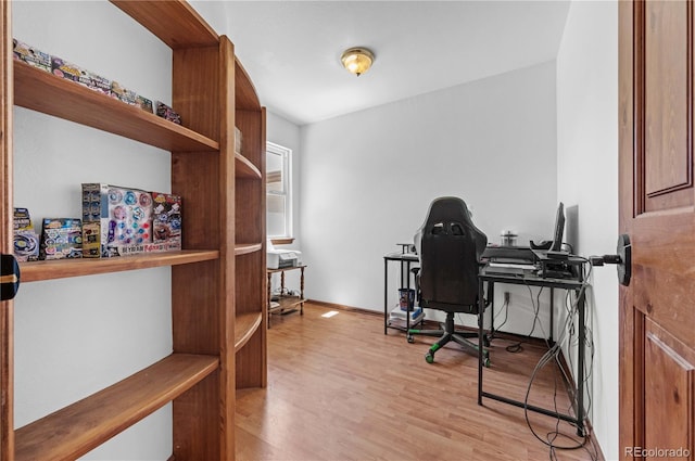 home office with light hardwood / wood-style floors