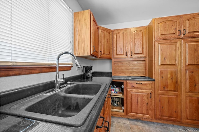 kitchen featuring sink and light tile patterned floors