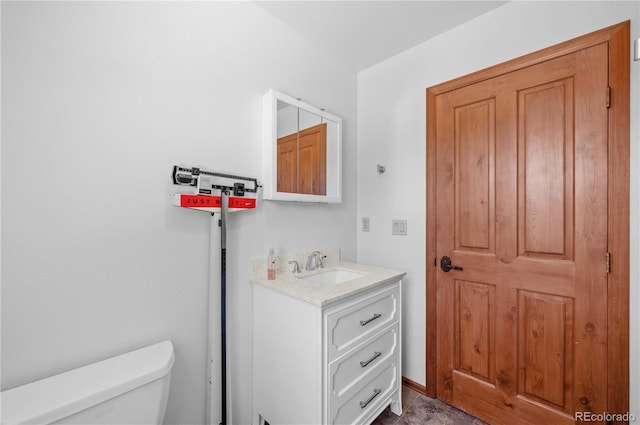 bathroom featuring toilet and vanity