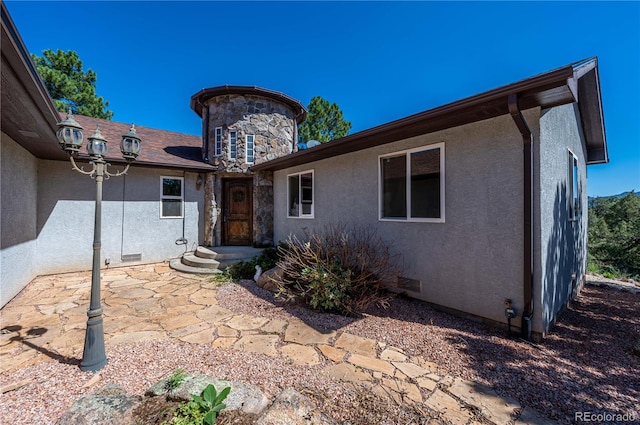 doorway to property featuring a patio area