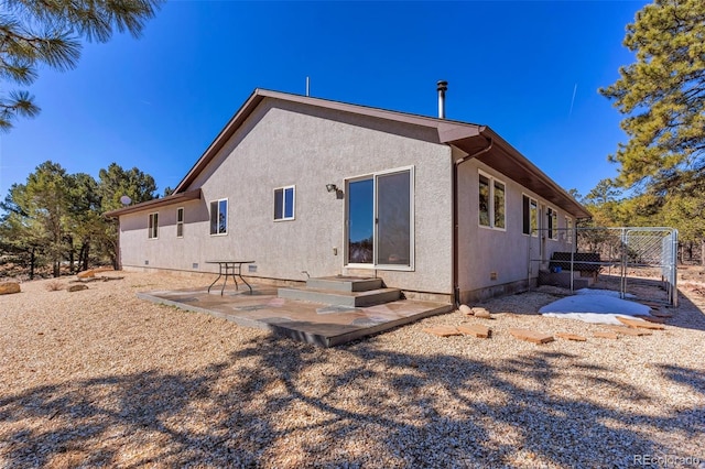 back of house with a patio