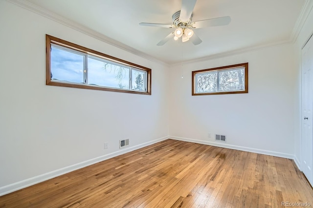 unfurnished bedroom with baseboards, visible vents, crown molding, and light wood-style flooring