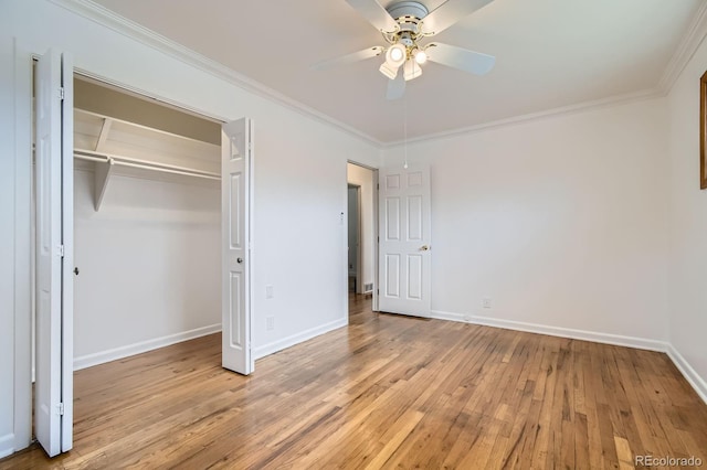 unfurnished bedroom featuring a closet, ornamental molding, baseboards, and light wood-type flooring