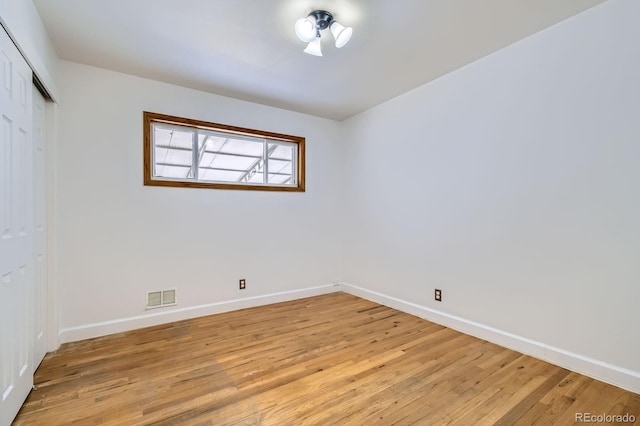 unfurnished room with baseboards, visible vents, and light wood-style flooring