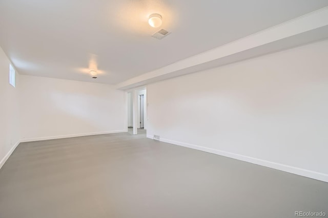 unfurnished room featuring baseboards, visible vents, and concrete floors