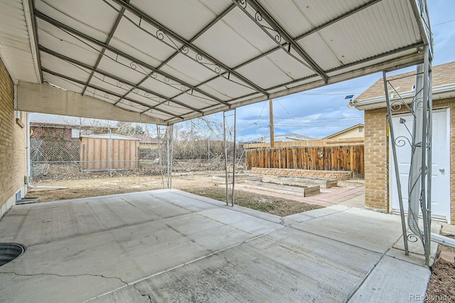 view of patio with fence, a storage shed, and an outdoor structure