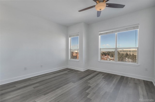 empty room with ceiling fan and dark hardwood / wood-style floors