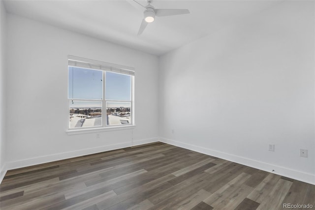 empty room featuring ceiling fan and dark hardwood / wood-style flooring