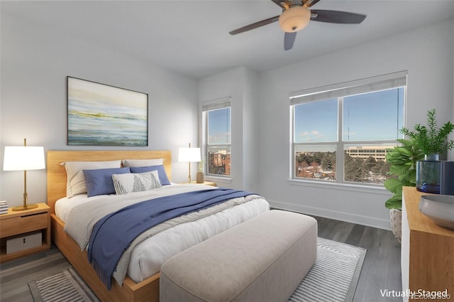 bedroom with ceiling fan, dark hardwood / wood-style flooring, and multiple windows