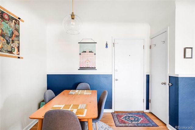 dining space featuring baseboards and wood finished floors