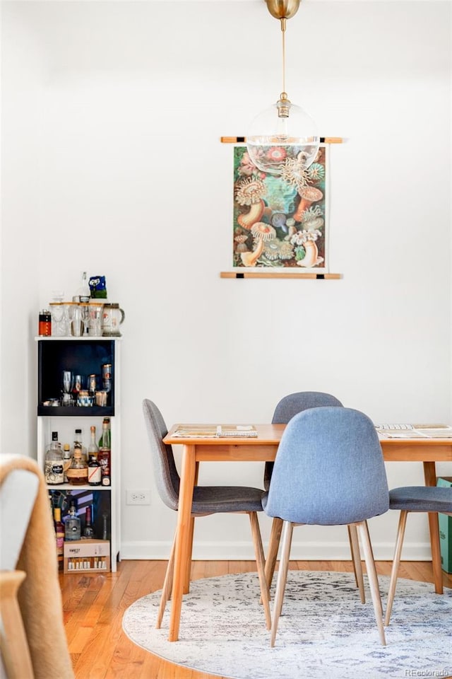 dining room featuring baseboards and wood finished floors