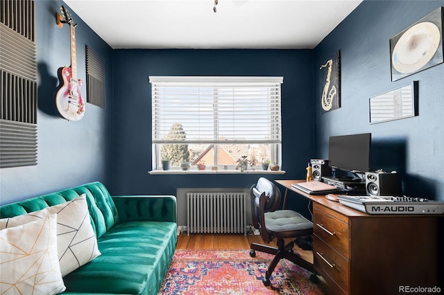 office space featuring radiator and wood finished floors