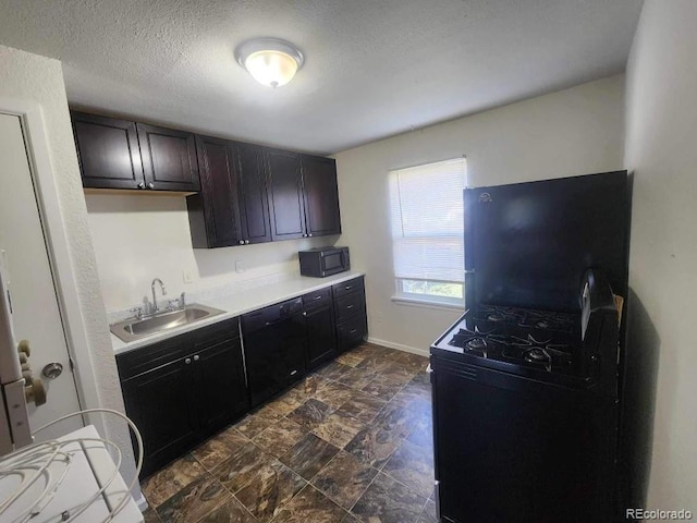 kitchen featuring sink, dark brown cabinetry, and a textured ceiling