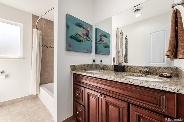 full bath featuring tile patterned floors, double vanity, visible vents, and a sink