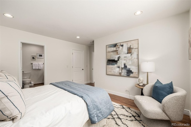 bedroom featuring wood finished floors and baseboards