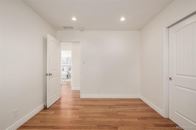 spare room featuring visible vents, recessed lighting, light wood-style floors, and baseboards