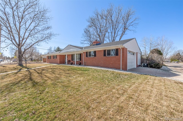 ranch-style home featuring an attached garage, a chimney, concrete driveway, a front lawn, and brick siding