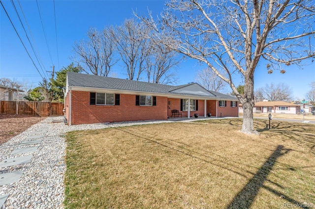 single story home with a patio area, brick siding, a front yard, and fence