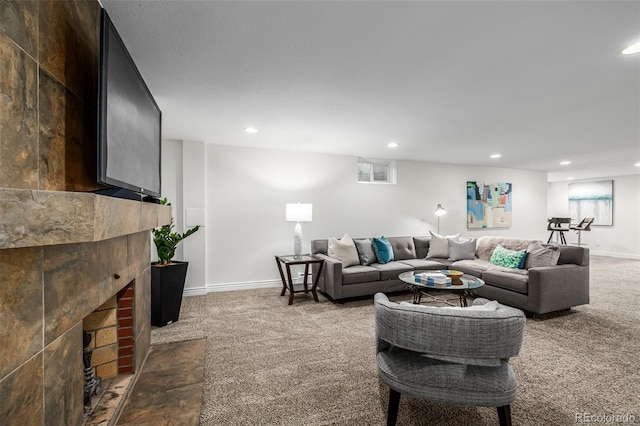 living area featuring recessed lighting, a brick fireplace, and dark carpet