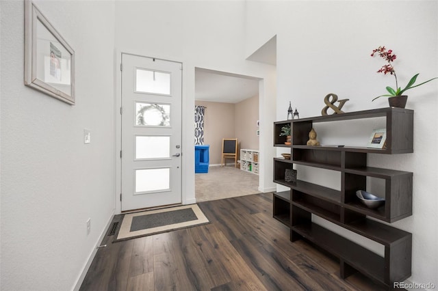 entryway featuring a wealth of natural light, baseboards, and dark wood-style floors