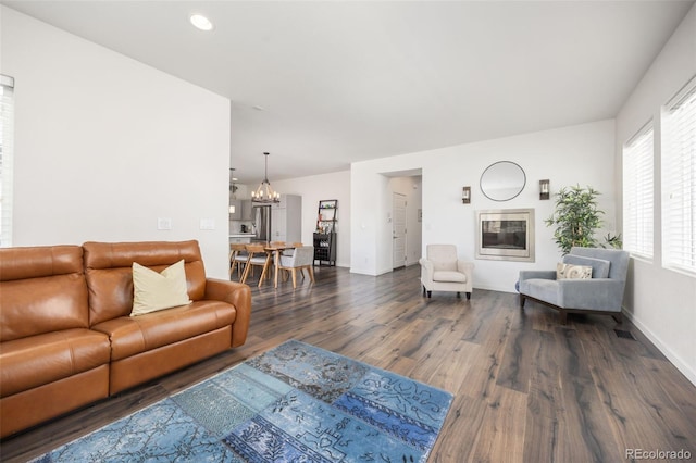 living room with a chandelier, baseboards, dark wood-style floors, and recessed lighting