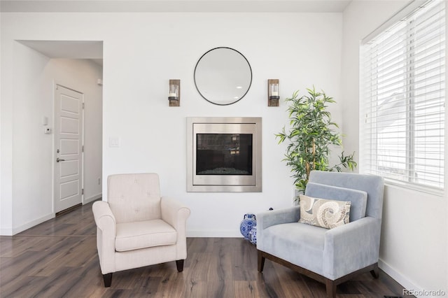 sitting room with baseboards and dark wood-style floors