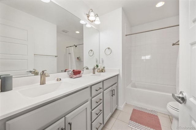 full bathroom featuring a sink, tile patterned flooring, toilet, and double vanity