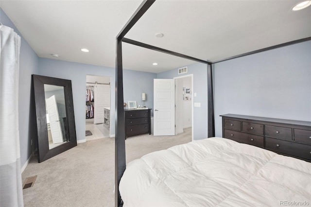bedroom with light colored carpet, visible vents, and recessed lighting