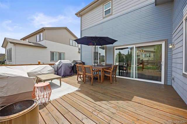 deck featuring area for grilling and outdoor dining space