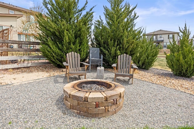 view of patio / terrace featuring an outdoor fire pit and fence