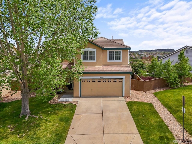 4963 Collingswood Dr, Highlands Ranch, CO 80130 - traditional-style home featuring a garage, stucco siding, driveway, and a tiled roof