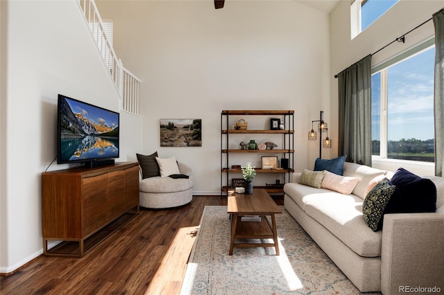 4963 Collingswood Dr, Highlands Ranch, CO 80130 - living area featuring a towering ceiling, wood finished floors, and baseboards
