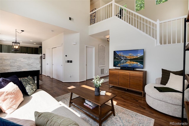 4963 Collingswood Dr, Highlands Ranch, CO 80130 - living area with stairway, dark wood-style floors, a high ceiling, baseboards, and a fireplace
