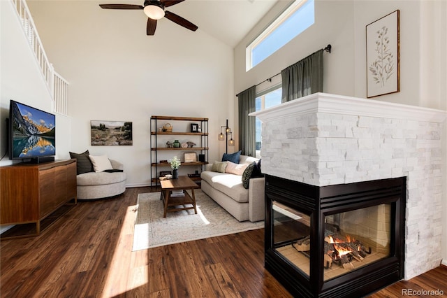4963 Collingswood Dr, Highlands Ranch, CO 80130 - living area with high vaulted ceiling, ceiling fan, dark wood finished floors, and a stone fireplace