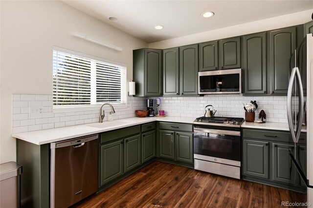 4963 Collingswood Dr, Highlands Ranch, CO 80130 - kitchen with appliances with stainless steel finishes, a sink, dark wood-style flooring, backsplash, and light countertops