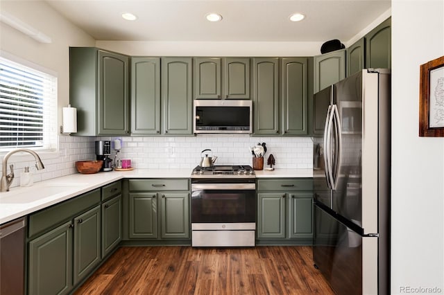 4963 Collingswood Dr, Highlands Ranch, CO 80130 - kitchen with appliances with stainless steel finishes, green cabinets, a sink, and recessed lighting