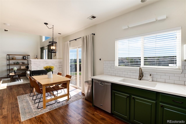 4963 Collingswood Dr, Highlands Ranch, CO 80130 - kitchen with dishwasher, a sink, green cabinetry, tasteful backsplash, and dark wood-style flooring