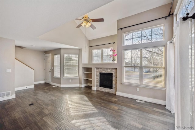 unfurnished living room with visible vents, baseboards, and wood finished floors