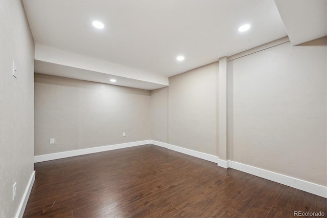 finished basement with recessed lighting, dark wood-style floors, and baseboards