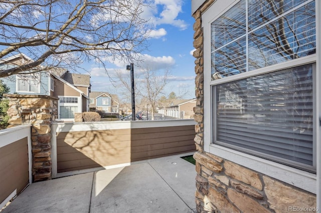 view of patio with a residential view and a balcony