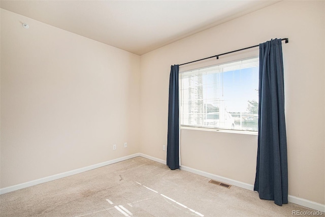 unfurnished room featuring light colored carpet