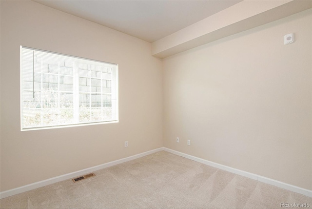 unfurnished room with light colored carpet