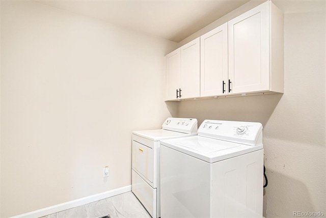 washroom with washing machine and dryer and cabinets