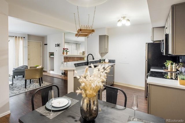 dining space with baseboards and dark wood finished floors