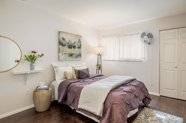 bedroom featuring a closet, wood finished floors, and baseboards