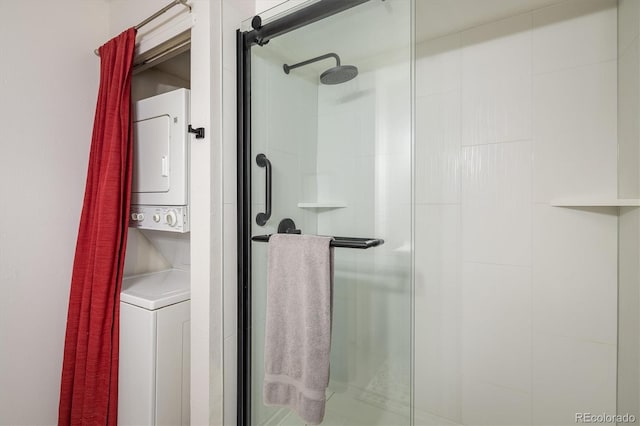 interior space featuring stacked washer and dryer and a stall shower