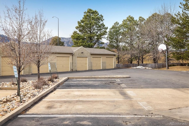 garage with fence and a mountain view